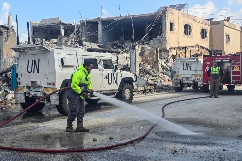 afp_69cab44db5b5-1774892109 United Nations peacekeepers with the UN Interim Force in Lebanon (UNIFIL) drive past firefighters clearing the road at the site of an overninght Israeli airstrike in the area of Naqura in southern Lebanon on March 27, 2026.