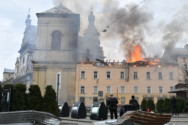 Fire and smoke raises above the city center following Russia's drone attack in Lviv, Ukraine, Tuesday, March 24, 2026. (AP Photo/Mykola Tys)