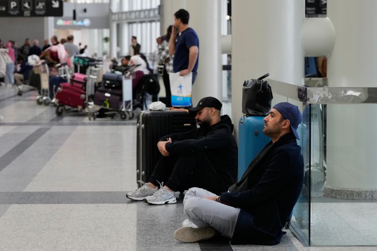 Passengers whose flights were cancelled, wait at the departure terminal of Rafik Hariri International Airport in Beirut, Lebanon, Saturday, Feb. 28, 2026, as many airlines canceled flights due to the conflict involving the United States, Israel and Iran. (AP Photo/Hassan Ammar)