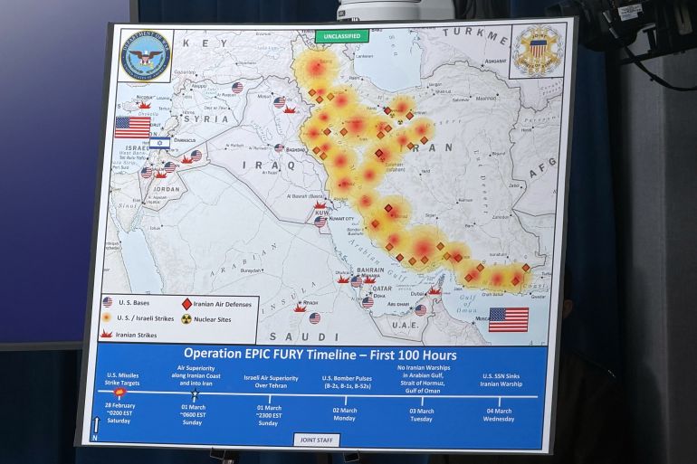 ap_69a834f587ffd-1772631285 A Dept. of Defense map entitled, Operation EPIC FURY Timeline - First 100 Hours, is displayed during a news conference with Defense Secretary Pete Hegseth and Chairman of the Joint Chiefs of Staff Gen. Dan Caine, at the Pentagon, Wednesday, March 4, 2026, in Washington. (AP Photo/Konstantin Toropin)