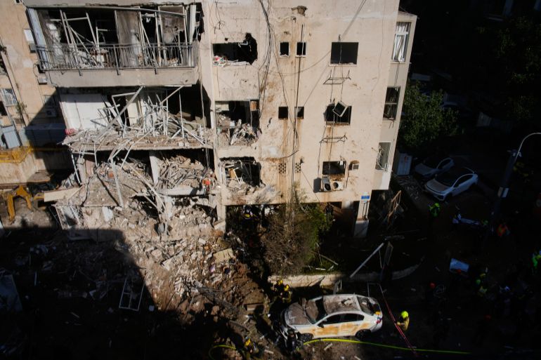 Israeli security forces and rescue team respond at the site of an Iranian missile strike in Tel Aviv, Israel, Tuesday, March 24, 2026. (AP Photo/Ohad Zwigenberg)