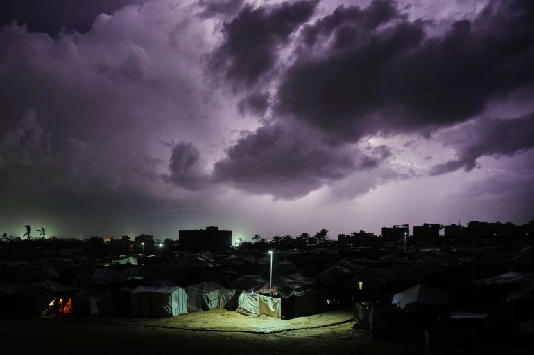 A thunderstorm is seen over a tent camp for displaced Palestinians in Zawaida, central Gaza Strip, Wednesday, Dec. 10, 2025. (AP Photo/Abdel Kareem Hana)