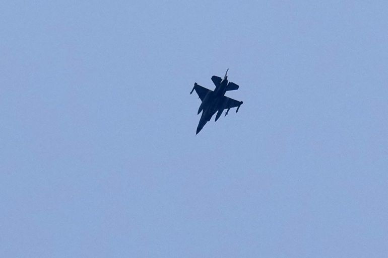 ap_69c7fc1f66616-1774713887 An Israeli warplane flies over the southern port city of Tyre, Lebanon, Saturday, March 28, 2026. (AP Photo/Hussein Malla)