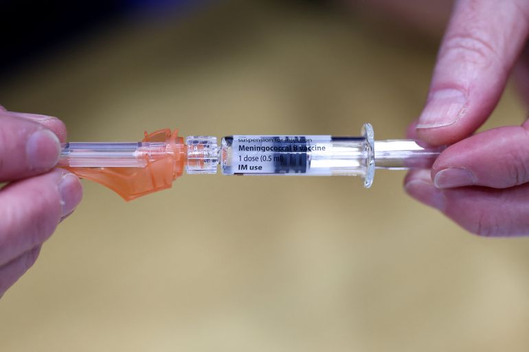 A member of the Kent Community Health NHS Trust immunisation team holds a Meningitis B vaccination, GSK (GlaxoSmithKline) Bexsero meningococcal group B vaccine, at a sports centre on the University of Kent campus, following an outbreak of meningitis cases in Kent, in Canterbury, Britain, March 20, 2026. REUTERS/Toby Melville