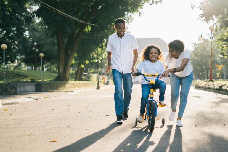d8b3d98ad8b4d8b0d8b3d8b0d8b4d8b0d9a5d9a6d9a4d9a52-1773493700 Man Standing Beside His Wife Teaching Their Child How to Ride Bicycle