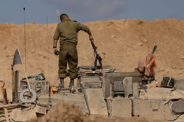 SOUTHERN ISRAEL, ISRAEL - OCTOBER 29: An Israeli soldiers stands on a tank near the border with the Gaza Strip on October 29, 2025 in Southern Israel, Israel. Israeli Prime Minister Benjamin Netanyahu ordered "immediate, powerful" strikes on Gaza Tuesday, after his office accused Hamas of violating the terms of the ceasefire agreement for returning remains that Israel says do not belong to any of the 13 unaccounted for hostages. The announcement of strikes followed reports of fighting in Rafah near the "yellow line" demarcating territory under IDF control in Gaza, according to the US-brokered ceasefire agreement that came into affect on October 10. (Photo by Amir Levy/Getty Images)