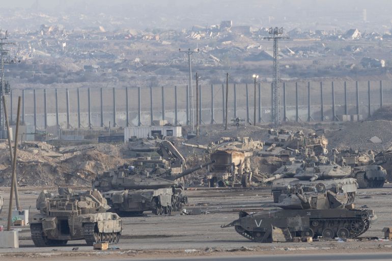 SOUTHERN ISRAEL, ISRAEL - OCTOBER 29: Israeli tanks stand near the border with the Gaza Strip as seen from a position on the Israeli side of the border on October 29, 2025 in Southern Israel, Israel. Israeli Prime Minister Benjamin Netanyahu ordered "immediate, powerful" strikes on Gaza Tuesday, after his office accused Hamas of violating the terms of the ceasefire agreement for returning remains that Israel says do not belong to any of the 13 unaccounted for hostages. The announcement of strikes followed reports of fighting in Rafah near the "yellow line" demarcating territory under IDF control in Gaza, according to the US-brokered ceasefire agreement that came into affect on October 10. (Photo by Amir Levy/Getty Images)