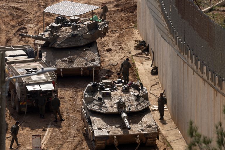 getty_69a8b81078-1772664848 NORTHERN ISRAEL, ISRAEL - MARCH 4: Israeli soldiers stand alongside tanks near the border with Lebanon on March 4, 2026 in northern Israel. Hezbollah, the Iran-backed militant group in Lebanon, launched missiles at Israel in what it said was retaliation for the joint U.S.-Israeli war on Iran. (Photo by Amir Levy/Getty Images)