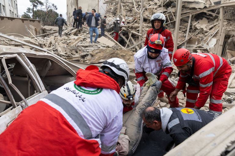 getty_69b884efa0-1773700335 TEHRAN, IRAN - MARCH 16: (EDITORS NOTE: Image contains graphic content) Emergency workers lift an injured woman onto a stretcher following a strike on a residential building on March 16, 2026 in central Tehran, Iran. The United States and Israel continued their joint attack on Iran that began on February 28. Iran retaliated by firing waves of missiles and drones at Israel, and targeting U.S. allies in the region. (Photo by Getty Images)