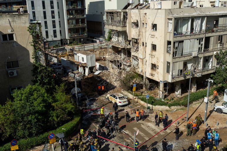 TEL AVIV, ISRAEL - MARCH 24: First responders gather near a crater left by an Iranian missile on March 24, 2026 in Tel Aviv, Israel. Israel is now fighting a war on two fronts - with Hezbollah in Lebanon and against Iran - after the United States and Israel launched a joint attack on Iran early on February 28th. (Photo by Erik Marmor/Getty Images)