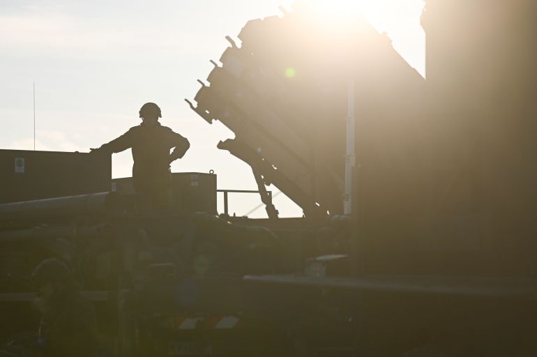 JASIONKA, POLAND - JANUARY 23: A german soldier stands on the top of a truck as he and others unload the US made MIM-104 Patriot surface-to-air missile (SAM) system on January 23, 2025 in Jasionka, Poland. Germany recently redeployed a Patriot air defense system in Poland, its NATO ally. (Photo by Omar Marques/Getty Images)