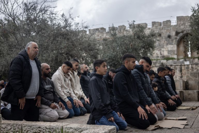 JERUSALEM, ISRAEL - JANUARY 24: Men take part in Friday prayer outside the entrance to Al-Aqsa Mosque at Lions Gate in the Old City as the Israel-Hamas ceasefire in Gaza continues on January 24, 2025 in Jerusalem, Israel. A total of 33 Israeli hostages, taken captive by Hamas and allied groups on Oct. 7, 2023, were to be released in the first phase of the Israel-Hamas ceasefire, in exchange for 1,890 Palestinian prisoners. The details of the second and third phases of the ceasefire have yet to be fully negotiated, but are supposed to entail the release of more hostages - some of whom are presumed dead - and the withdrawal of Israel troops from Gaza. (Photo by Chris McGrath/Getty Images)