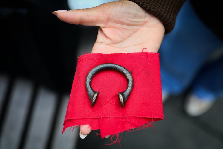gettyimages-2177473898-1774490205 LONDON, ENGLAND - OCTOBER 12: A participant of the tour holds a manilla, a metal which gradually became the principal currency of the slave trade. on October 12, 2024 in London, England. Founded in 2020 by Black historian and researcher, Darrel Blake, the City Of London: Slave Trade Money Trail Tour uncovers the untold history of Britain's early involvement in the transatlantic slave trade. The tour explores the historical ties between London's financial institutions and the plantation economy, exposing how wealth from the slave trade helped shape the city. Driven by a desire to challenge the conventional narratives of British history, Darrel runs the walking tour from March to December, with special events during Black History Month in October.(Photo by Alishia Abodunde/Getty Images)
