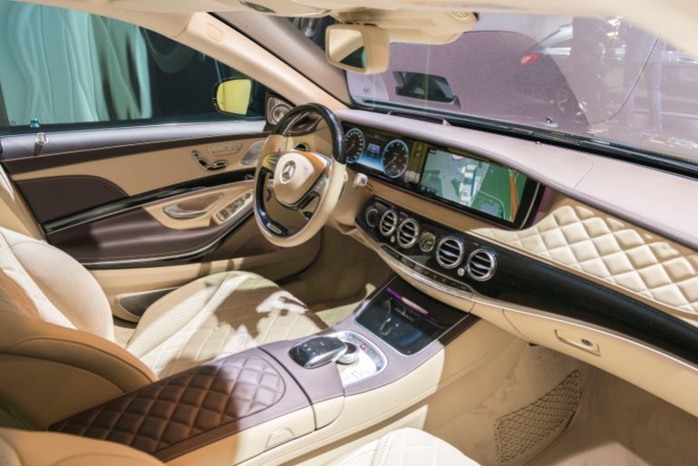 Brussels, Belgium - Januari 12, 2016: Luxurious interior on a Mercedes-Maybach S500 4Matic luxury limousine sedan. The vehicle is fitted with light leather seats, wood trim and a large information display on the dashboard. Mercedes-Maybach is the top luxury brand of German car manufacturer Mercedes-Benz. The car is on display during the 2016 Brussels Motor Show.