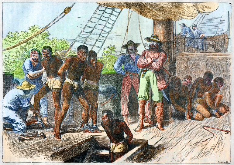 gettyimages-526614264-1774490188 African slaves being taken on board ship bound for USA - engraving 1881 (Photo by Stefano Bianchetti/Corbis via Getty Images)