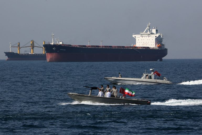 Iranian soldiers take part in the "National Persian Gulf day" in the Strait of Hormuz, on April 30, 2019. The date coincides with the anniversary of a successful military campaign by Shah Abbas the Great of Persia in the 17th century, which drove the Portuguese navy out of the Hormuz Island, after which is named the waterway which separates the Gulf from the Sea of Oman. (Photo by ATTA KENARE / AFP)