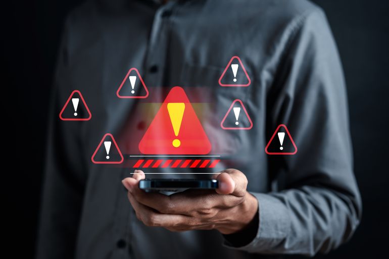 phone-warrning1-1772278836 Warning caution sign for notification error and maintenance concept. cyber attack on computer network. Cybersecurity vulnerability, data breach, illegal connection, compromised information.