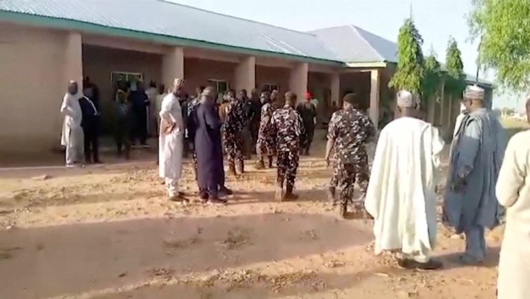 Government officials and police officers stand in the school compound, after gunmen attacked a government girls' boarding school in Nigeria's Kebbi State on November 17, killing the vice principal and abducting 25 female students, according to police, Kebbi, Nigeria, in this screengrab taken from a handout video released on November 18, 2025. Africa Independent Television/Handout via REUTERS THIS IMAGE HAS BEEN SUPPLIED BY A THIRD PARTY. NIGERIA OUT. NO COMMERCIAL OR EDITORIAL SALES IN NIGERIA