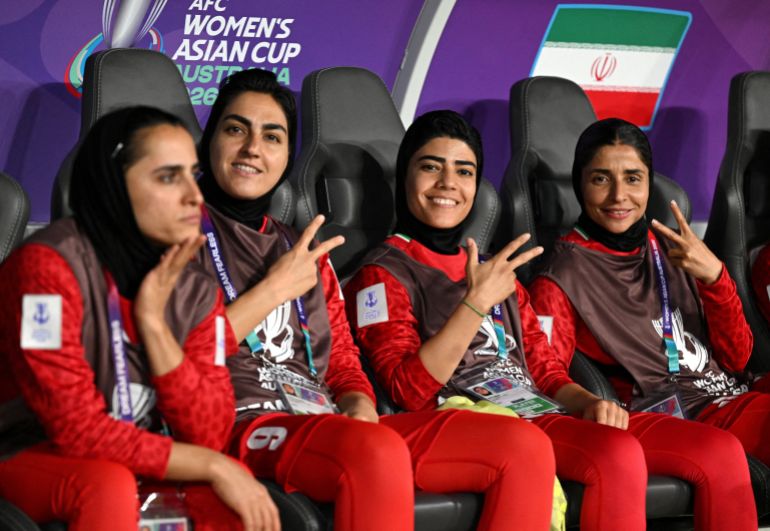 Soccer Football - AFC Women’s Asian Cup - Group A - Iran v Philippines - Gold Coast Stadium, Gold Coast, Australia - March 8, 2026 Iran players Zahra Ghanbari, Mona Hamoudi and Atefeh Ramezanizadeh react from the bench Dave Hunt/AAP Image via REUTERS ATTENTION EDITORS - THIS IMAGE WAS PROVIDED BY A THIRD PARTY. NO RESALES. NO ARCHIVES. AUSTRALIA OUT. NEW ZEALAND OUT