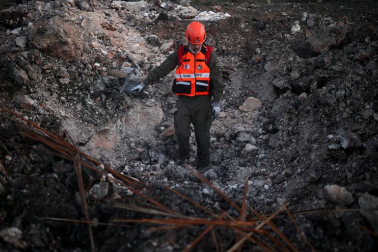 An Israeli emergency responder works at the site of an impact by an Iranian missile, amid the U.S.-Israel conflict with Iran, in northern Israel, March 13, 2026. REUTERS/Shir Torem