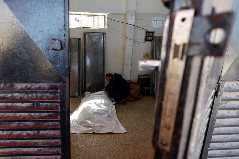 A mourner reacts next to the body of Ezzeldin Al-Telbani, a Palestinian killed in an Israeli air strike on a house on Tuesday, according to medics, during his funeral, at Al-Aqsa Martyrs Hospital in Deir al-Balah, in the central Gaza Strip, March 11, 2026. REUTERS/Mahmoud Issa