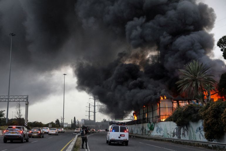 reuters_69b6b75f-1773582175 Fire ignited at the impact site following an Iranian missile strike, amid the U.S.-Israeli conflict with Iran, in central Israel March 13, 2026. REUTERS/Gideon Markowicz ISRAEL OUT. NO COMMERCIAL OR EDITORIAL SALES IN ISRAEL TPX IMAGES OF THE DAY