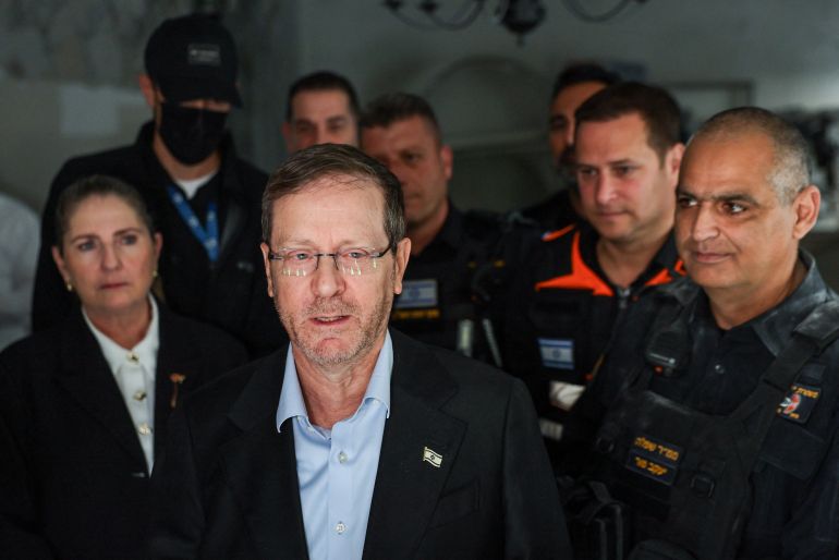 Israel's President Isaac Herzog visits an house that was damaged by a projectile strike, amid the U.S.-Israeli conflict with Iran, in Rishon LeZion, Israel, March 16, 2026. REUTERS/Tyrone Siu
