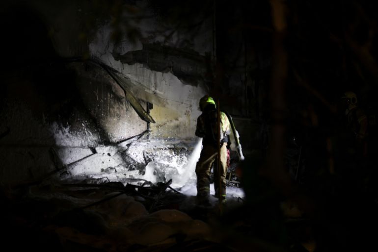 Firefighters work at the scene of a Hezbollah rocket attack on a residential building, amid escalation between Hezbollah and Israel, and amid the U.S.-Israeli conflict with Iran, in Nahariya, northern Israel, March 16, 2026. REUTERS/Shir Torem