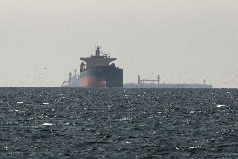 FILE PHOTO: Cargo ships in the Gulf, near the Strait of Hormuz, as seen from northern Ras al-Khaimah, near the border with Oman’s Musandam governance, amid the U.S.-Israeli conflict with Iran, in United Arab Emirates, March 11, 2026. REUTERS/Stringer/File Photo REFILE - CORRECTING "TANKERS" TO "CARGO SHIPS" AND REMOVING ACTION "SAIL".