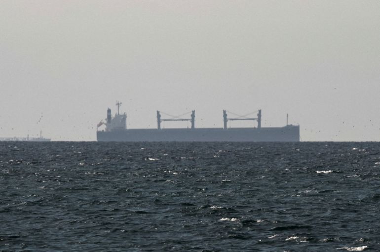 FILE PHOTO: A cargo ship in the Gulf, near the Strait of Hormuz, as seen from northern Ras al-Khaimah, near the border with Oman’s Musandam governance, amid the U.S.-Israeli conflict with Iran, in United Arab Emirates, March 11, 2026. REUTERS/Stringer/File Photo REFILE - CORRECTING "TANKER" TO "CARGO SHIP" AND REMOVING ACTION "SAILS".