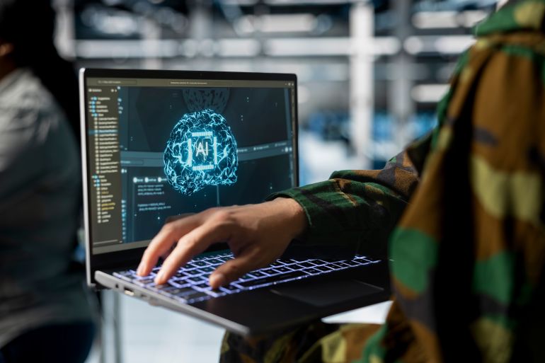 Close up of army tech expert in data center running simulations with military grade defense artificial intelligence. Server farm worker configuring AI dashboards to support mission decisions