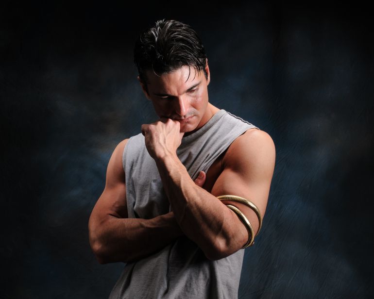 The sexy man poses for the camera.