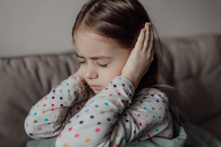 shutterstock_2137888515-1772983534-1 Stop war. Pray for Ukraine. we stand with Ukraine. Ukrainian frightened child under a blanket. The girl is afraid of the sounds of air raids and explosions. Poor child feeling sorrow and sadness.; Shutterstock ID 2137888515; purchase_order: aj; job: ; client: ; other: