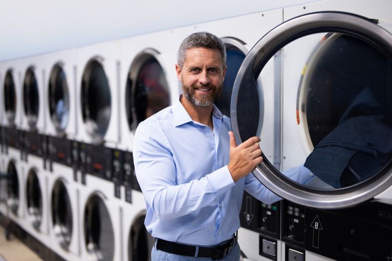 Tight schedule and time management. Effective planning in schedule. Well-organized man in public laundry. Work-life balance. Overloaded schedule for busy mature business man. Busy schedule.; Shutterstock ID 2606018641; purchase_order: aj; job: ; client: ; other: