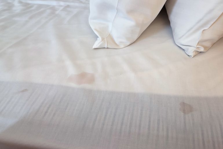Dirty stained linen bedsheet in hotel room due to lack of quality control; Shutterstock ID 2682551553; purchase_order: aj; job: ; client: ; other: