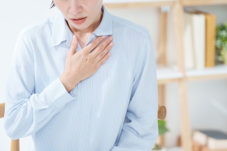 A woman experiencing pain in her chest; Shutterstock ID 2703991619; purchase_order: aj; job: ; client: ; other: