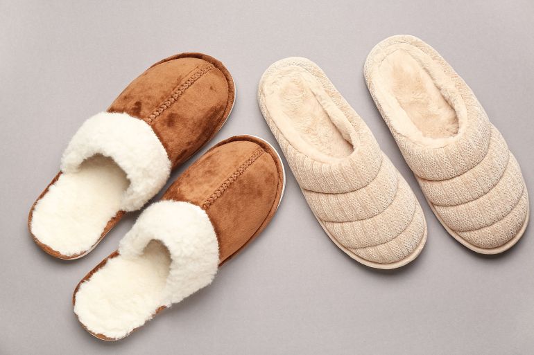 Two pairs of soft slippers on grey background. Top view; Shutterstock ID 2719667095; purchase_order: aj; job: ; client: ; other: