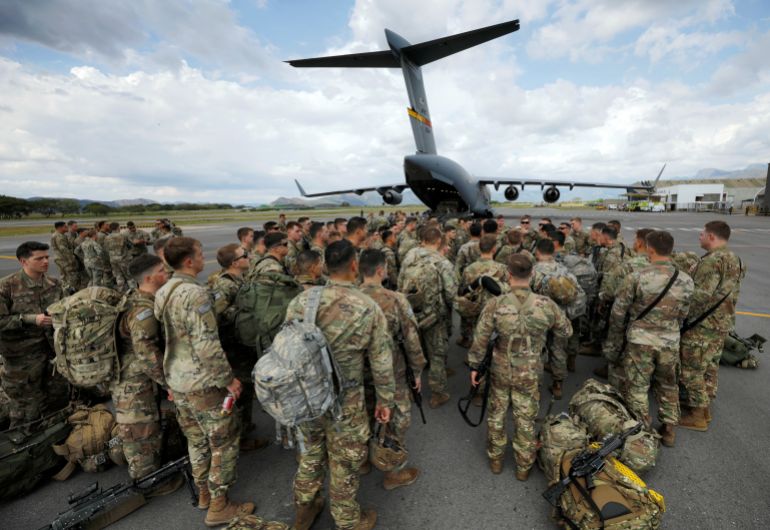 Paratroopers from the U.S. Army's 82nd Airborne Division gather after disembarking from a C-17 transport plane that took them to Colombia to participate in a multinational exercise, at Tolemaida Air Base, Colombia January 23, 2020. REUTERS/Jonathan Drake