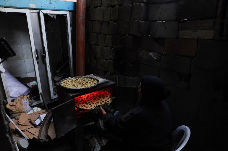 With no cooking gas available, Samira is forced to use broken wooden furniture as fuel [Abdelhakim Abu Riash/Al Jazeera]