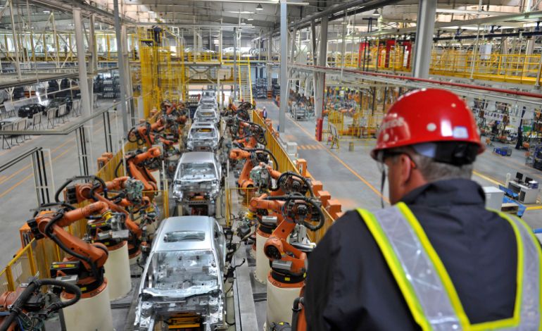 An employee looks at an assembly line at a Ford manufacturing plant in Chongqing municipality April 20, 2012. The new Ford car massive manufacturing plant, which opened in February, will need to be a success if Ford is to get a better foothold in the world's biggest car market, where it badly lags rivals such as General Motors Co and Volkswagen AG, which together produced the six top-selling cars in the country in 2011. Ford -- which was late getting into China -- had just 2.8 percent of the 18.5 million vehicle market last year, against GM's 14 percent and VW's 12 percent. Picture taken April 20, 2012. To match FEATURE FORD-CHINA/ REUTERS/Stringer (CHINA - Tags: TRANSPORT BUSINESS) CHINA OUT. NO COMMERCIAL OR EDITORIAL SALES IN CHINA