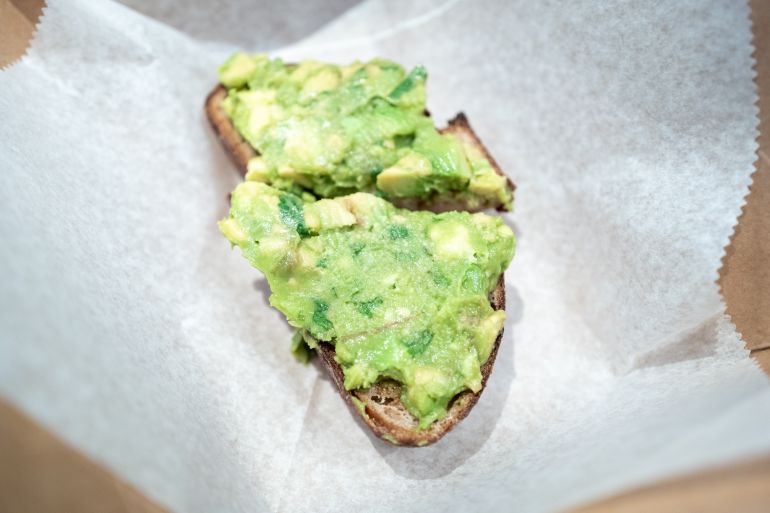 Close-up of sliced avocado toast on parchment paper in takeout container, San Francisco, California, December 29, 2025. (Photo by Smith Collection/Gado/Getty Images)
