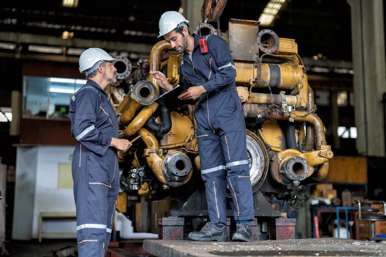 In heavy industry maintenance manager meet engineer checking and agreement hand check and sign on work schedule to overhaul mega 1000 horse power machine with electric generator supercharger turbo