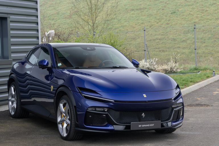Nancy, France - March 17th 2024 : Focus on a blue Ferrari Purosangue parked on a parking lot.