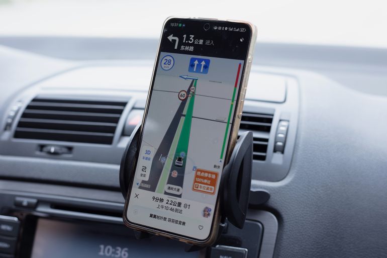 Beijing, China - October 6, 2024: A driver uses the Auder Map APP to navigate to his destination. Beidou Navigation Satellite System (BDS) is a global satellite navigation system developed by China.