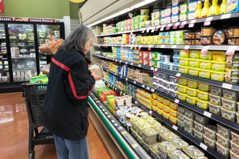 Spencer, Wisconsin, March,30, 2018 Woman Grocery shopper reading the label on a product; Shutterstock ID 1058532146; purchase_order: d; job: ; client: ; other: