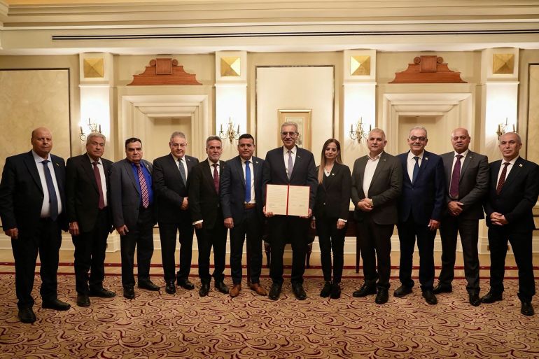654-1770649288 علي شعث A handout photograph released by Egypts State Information Service shows Ali Shaath (C), head of the new Palestinian technocratic committee for administering the Gaza Strip, posing with its members during the inaugural meeting of 'National Committee for the Administration of Gaza' (NCAG), in Cairo on January 18, 2026. (Photo by Egypts State Information Service / AFP) / RESTRICTED TO EDITORIAL USE - MANDATORY CREDIT "AFP PHOTO/EGYPTS STATE INFORMATION SERVICE" - HANDOUT - NO MARKETING NO ADVERTISING CAMPAIGNS - DISTRIBUTED AS A SERVICE TO CLIENTS