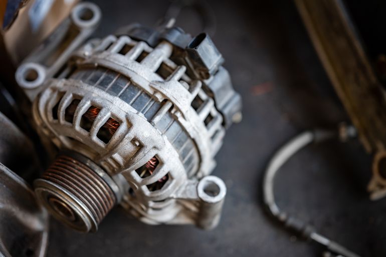 Car alternator or car starter dynamo part. Auto repair and maintenance service in the garage. Mechanical engineering and automotive industry