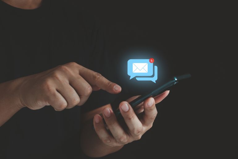 Business email communication and digital marketing technology. Stay connected with e-mail notifications! A businessman checks his inbox on his phone, keeping up with work and life on the go.