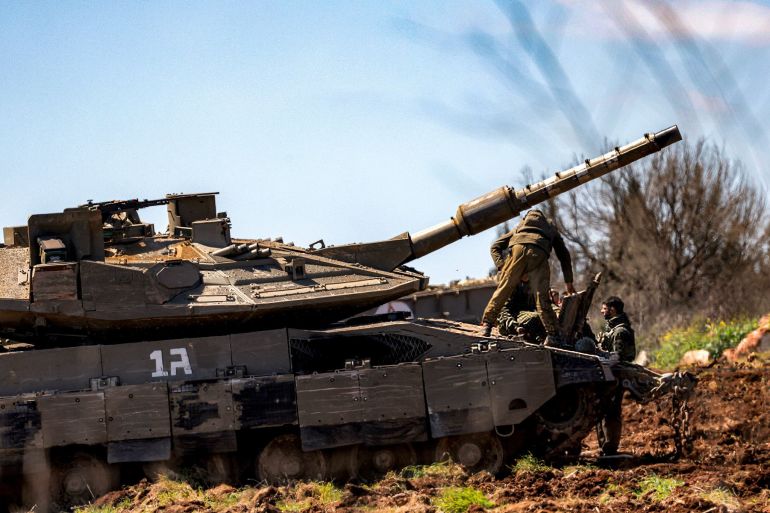 989889-1777547432 An Israeli army soldier stands on a Merkava main battle tank deployed at a position in the upper Galilee in northern Israel near the Lebanon border on March 9, 2026. Israel's military began striking southern Lebanon on March 4 after issuing a call to evacuate all areas south of the country's Litani river. Lebanon was drawn into the Middle East war when Iran-backed militant group Hezbollah attacked Israel in response to the killing of Iranian supreme leader during US-Israeli strikes. (Photo by Jalaa MAREY / AFP via Getty Images)