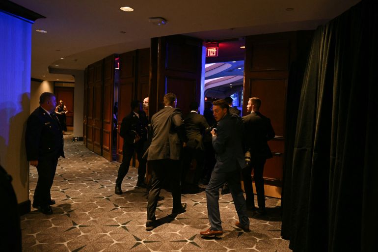 Reporters react after loud bangs were heard during the White House Correspondents' dinner at the Washington Hilton in Washington, DC, on April 25, 2026. President Trump was evacuated from the dinner, which he was attending for the first time while in office. (Photo by Mandel NGAN / AFP)